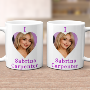 Two white mugs with purple text reading 'I Sabrina Carpenter' and a heart-shaped photo of the celebrity on a wooden surface.