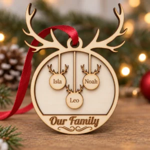 Wooden Christmas ornament shaped like a reindeer head with hanging circular cutouts displaying the names Amelia and Noah and the phrase Our Family