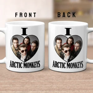An 11oz white ceramic mug printed with black ink showing the text I Love ARCTIC MONKEYS and a group photo of the band inside a heart shape.