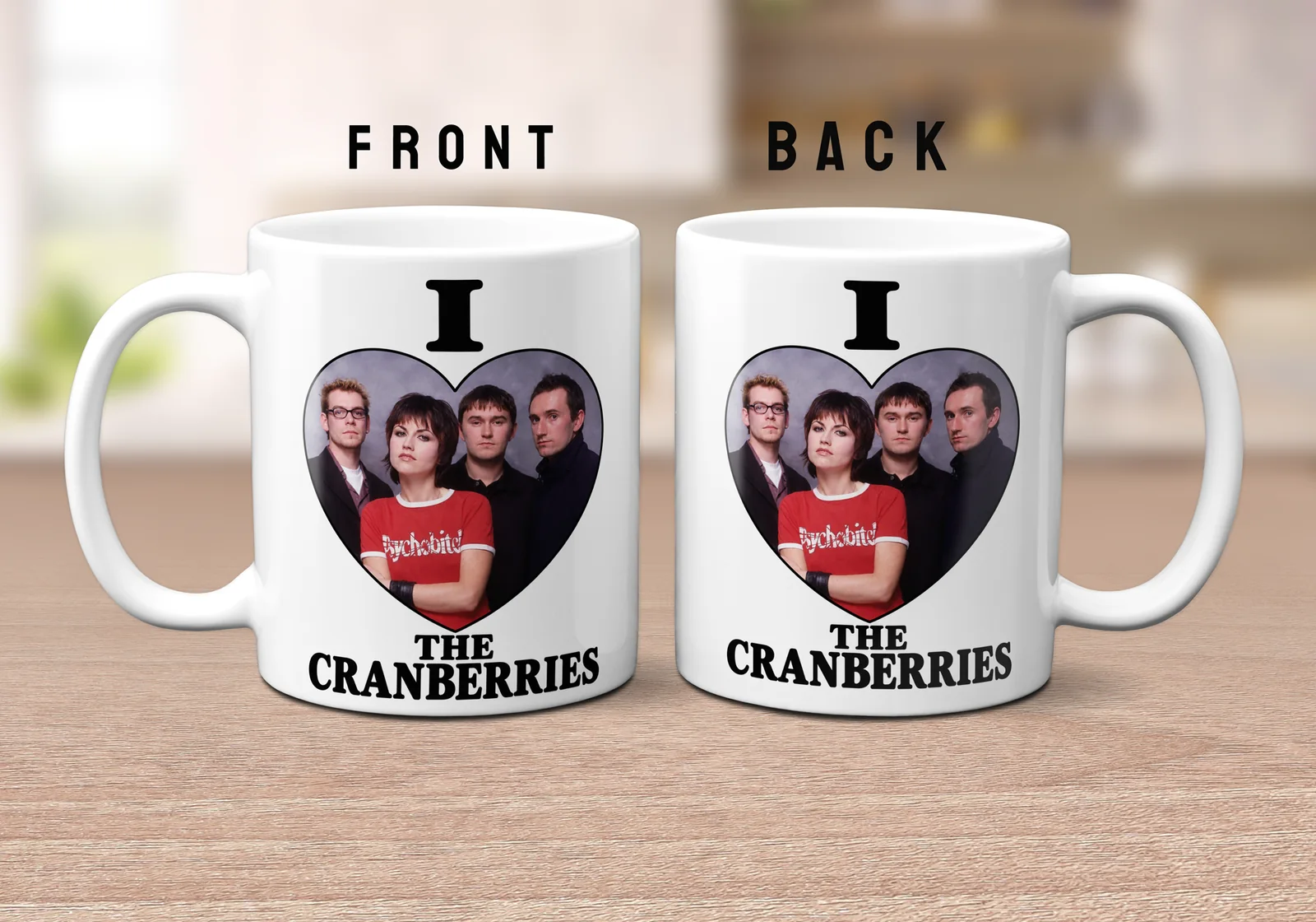 I Love THE CRANBERRIES design on an 11oz ceramic mug featuring a band photo inside a heart and black text.